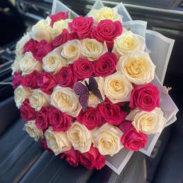 Bouquet of pink and cream roses with a butterfly decoration