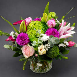 Pink and white mixed flower arrangement in a glass vase