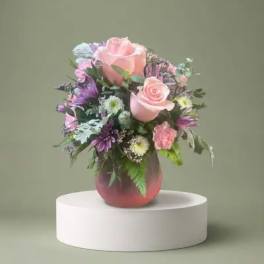 Pink and purple mixed bouquet in a glass vase