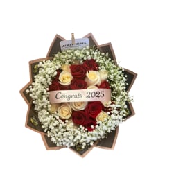 Bouquet of red and cream roses with a congratulatory ribbon
