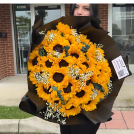 Bouquet of yellow sunflowers wrapped in black paper