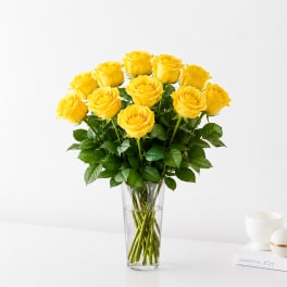 Yellow roses arranged in a clear glass vase