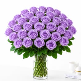Bouquet of lavender roses in a clear glass vase