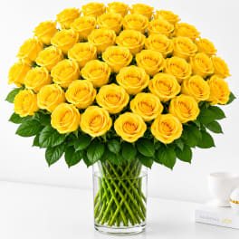 Bouquet of yellow roses in a clear glass vase