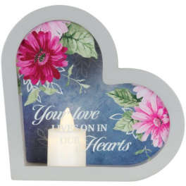 Heart-shaped memorial plaque with floral print and a small candle