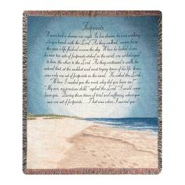 Fringed woven blanket with a beach scene and printed poem text