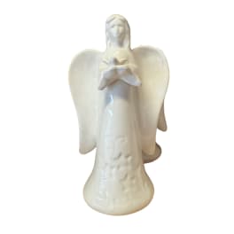 White ceramic angel figurine holding a flower