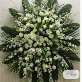 Large white floral standing spray with roses and lilies