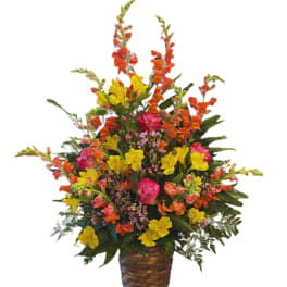 Bright mixed flower arrangement in a woven basket