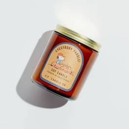 Amber soy candle in a glass jar with a gold lid