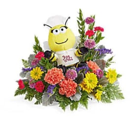 Colorful flower arrangement with a bee plush centerpiece
