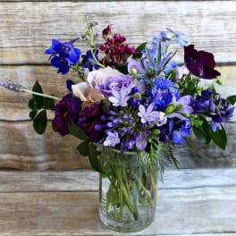 Mixed purple and blue bouquet in a clear glass vase