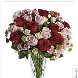 Bouquet of red and pink roses in a clear glass vase