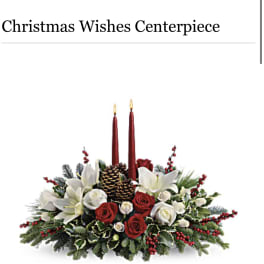 Christmas centerpiece with red candles, white lilies, and red roses