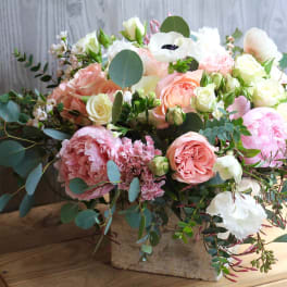 Mixed pastel bouquet in a rustic wooden box