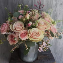 Pink and cream rose bouquet in a ribbed metal vase