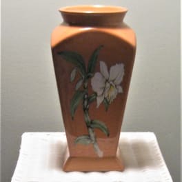Decorative ceramic vase with a painted white flower motif