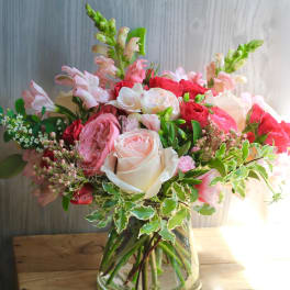 Pink and white rose bouquet in a glass vase