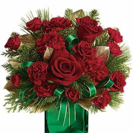 Red roses and carnations in a green glass vase with ribbon
