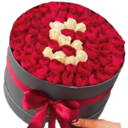 Round box filled with red and white roses arranged in a heart shape