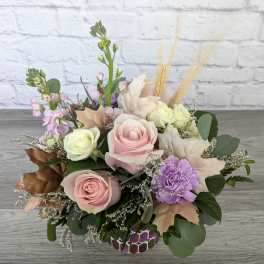 Pastel rose and carnation bouquet in a patterned vase