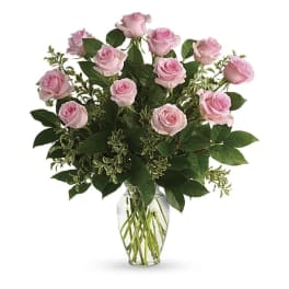 Pink roses arranged in a clear glass vase