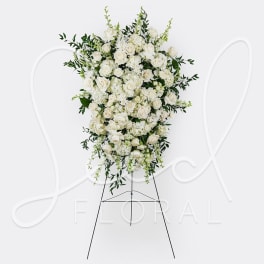 Tall white floral standing spray on an easel