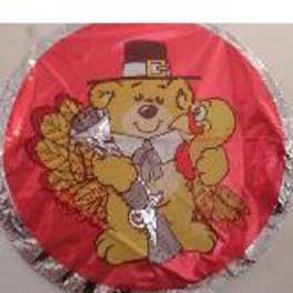 Round red balloon with a teddy bear wearing a hat and tie