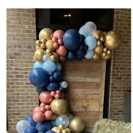 Large balloon garland in blue, gold, pink, and clear balloons