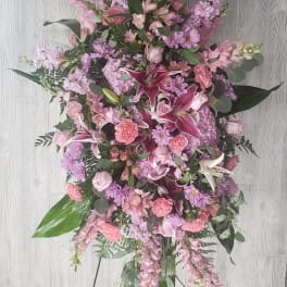 Tall pink and lavender floral standing spray on an easel