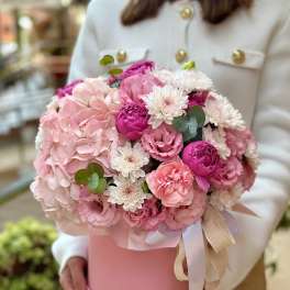Pink and white bouquet in a pink hat box with ribbon