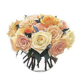 Round glass bowl filled with tightly clustered cream, peach, and yellow roses.