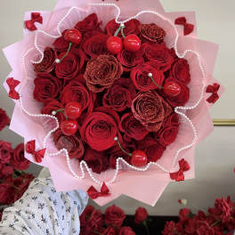 Bouquet of red roses with pink wrapping and red ribbon bows