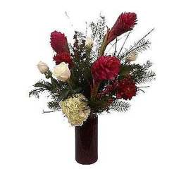 Tall red and white flower arrangement in a dark red cylinder vase