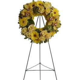 Yellow rose and gerbera daisy wreath with orchids on a metal easel stand