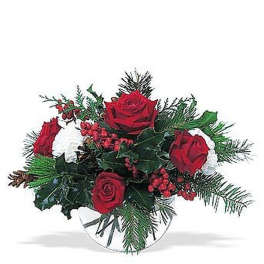 Low arrangement of red roses, white flowers, and red berries in a clear glass bowl