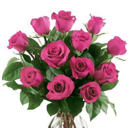 Bouquet of bright pink roses arranged in a round clear glass vase