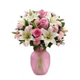 Pink roses and white lilies arranged in a pink vase