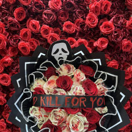 Bouquet of red and cream roses with a skull decoration