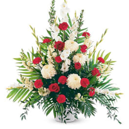 Red roses and white flowers in a white vase