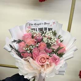 Pink rose bouquet with white baby's breath and paper wrapping
