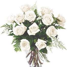 Arrangement of white roses in a clear glass vase