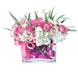 Low pink and white rose and hydrangea arrangement in a clear rectangular vase with pink ribbon