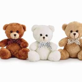 Three teddy bears with polka-dot bows sit side by side.