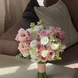 Pink and white bridal bouquet with roses and ruffled blooms