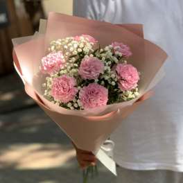 Pink carnation bouquet wrapped in blush paper