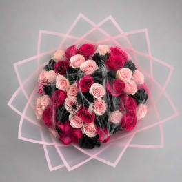 Round bouquet of pink and black roses with pink geometric wrap