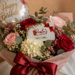Birthday bouquet with roses, hydrangea, and a balloon