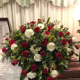 Red and white rose spray on a casket