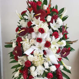 Large red and white funeral spray on an easel